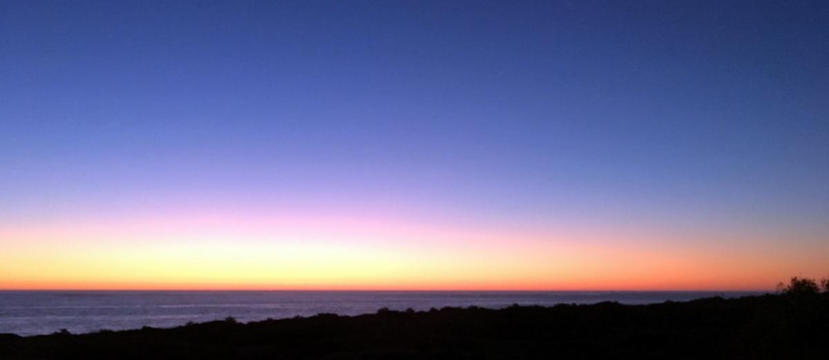Stunning sunset over the ocean near Perth, Western Australia, with a gradient sky shifting from deep blue to soft orange and pink. A peaceful coastal view perfect for Retirement Wanderlust, inspiring a serene, travel-focused retirement lifestyle.