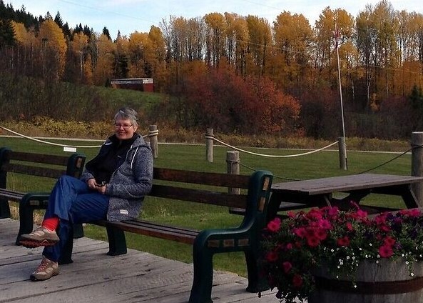Dee, founder of Retirement Wanderlust, enjoying a quiet moment outdoors.